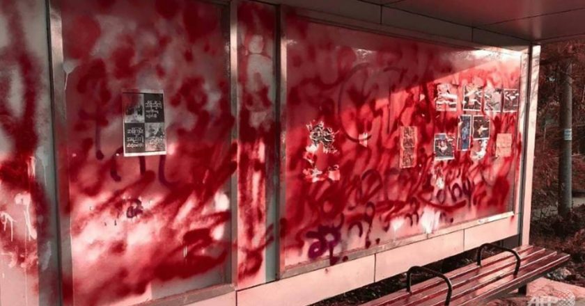Myanmar anti-coup protesters throw red paint in the streets as death toll mounts