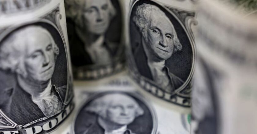 Dollar rises on risk aversion; euro revisits parity