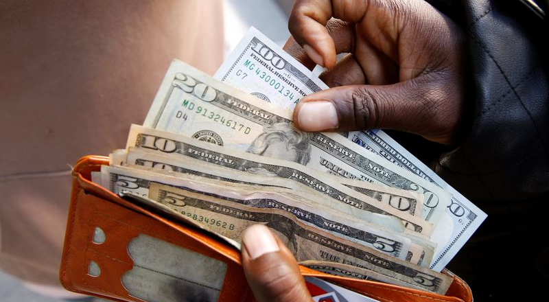 Dollar falls ahead of data releases, risk of US government shutdown looms